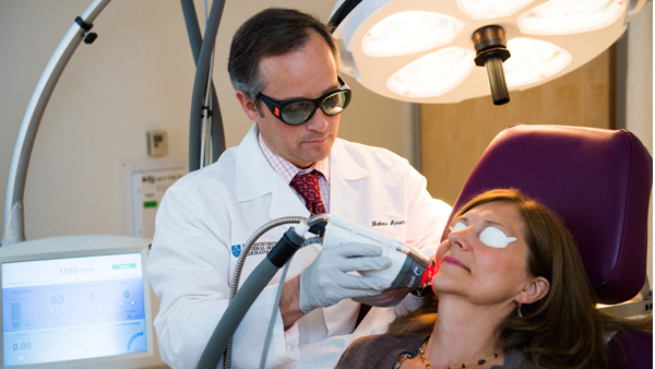 Dr. Avram using a fractional laser to improve a patient's skin appearance. Dr. Avram using a fractional laser to improve a patient's skin appearance.