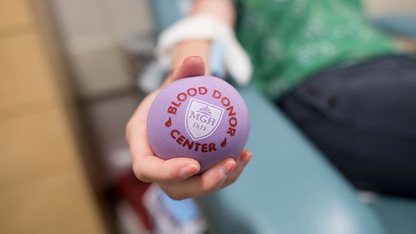 A blood donor holds a Mass General stress ball