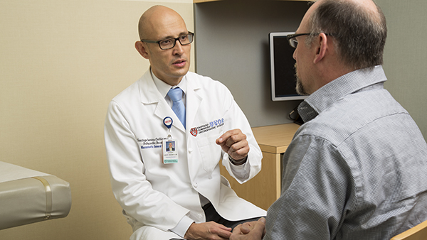 Dr. Santiago Calderon with a patient
