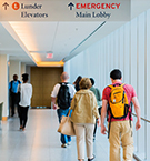 Hallway of Mass General with Emergency Department sign hanging from ceiling