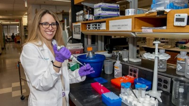 Women in a lab coat doing research