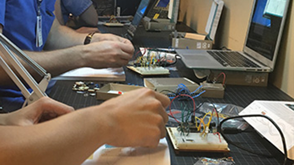 Students adjust wires connected to computers