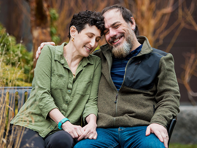 Stefanie London and Jonathan Reich siting together on a bench Stefanie London and Jonathan Reich siting together on a bench