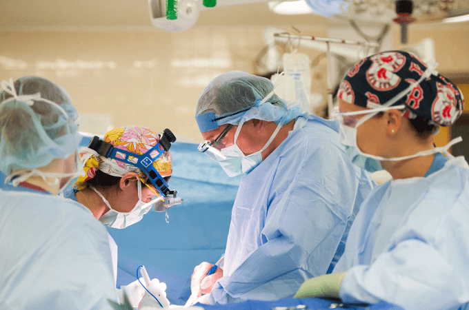 male caucasian doctor taking blood pressure of male, African American patient